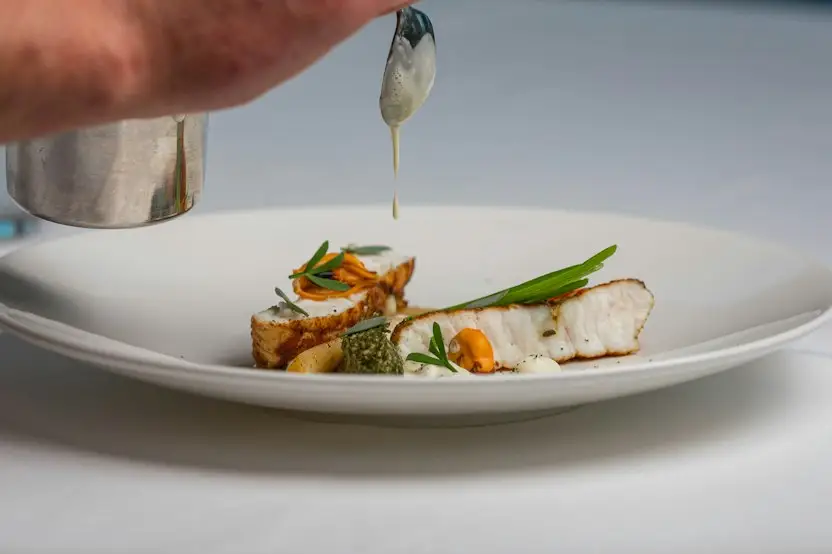 Beautifully plated fish dish with vegetables